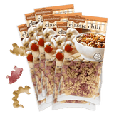 Pastabilities Classic Chili 6-pack, angled view of packaging with bowl of chili and tricolor pasta on green background