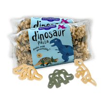 Front view of 14 oz Dinosaur Pasta bag with blue label and clear window showing small dinosaur-shaped noodles on white