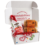 Front view of two 14 oz Halloween Pasta bags with orange label and pumpkin, ghost, and spiderweb-shaped pasta on white