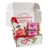 Front view of two 14 oz Kiss Me Pasta bags showing pink label and tri-color heart- and kiss-shaped pasta on white background