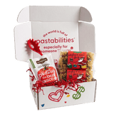 Front view of two 14 oz Naughty or Nice pasta bags showing red label and mixed holiday-shaped pasta on white background