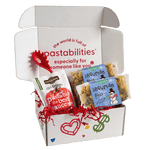 Front view of two-pack Snowman Pasta showcasing snowman label and green and yellow snowman- and snowflake-shaped pasta on white background