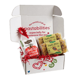 Front view of Tennis Pasta bag showcasing yellow and red tennis racquet-shaped pasta through clear packaging on white background