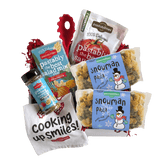 Front view of Snowman Pasta showing snowman label and green and yellow snowman- and snowflake-shaped pasta on white