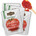 Angled view of Pastably pasta sauce pouches with tomato and text 'Pastably the best sauce ever' and wooden spoon of red sauce